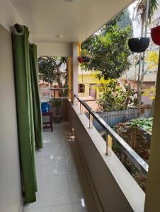 a balcony of a building with a view of a garden at Deep Home stay in Agartala