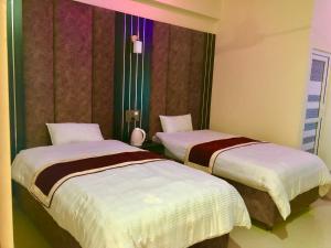 Una cama o camas en una habitación de Hotel Hot Pot, Dhangadhi