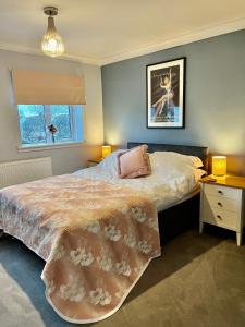 a bedroom with a large bed and a window at St Martin’s view in Haverfordwest