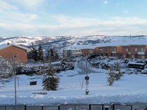 a town covered in snow with houses and trees at B&B Nausica in Ripalimosani