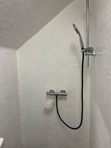 a shower in a bathroom with a hose at Dammyr, close to City with parking in Fredrikstad