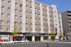 an empty street in front of a large building at Kyoto Daiichi Hotel in Kyoto