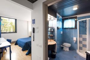 łazienka z łóżkiem, toaletą i umywalką w obiekcie Hotel Martini w Weronie