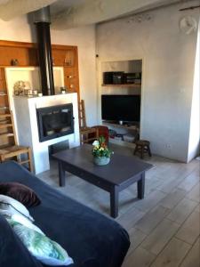 a living room with a couch and a coffee table at Maison de village vue montagne in La Gaude