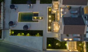 an aerial view of a building with a pool at night at Eleanthi Modern Living in Galatás