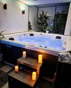 a large tub in a room with candles at Luxury 9ine SUPER BEAUTIFUL JACUZZI APARTMENT WITH BALCONY in Birmingham