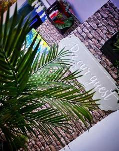 a palm tree next to a sign for a store at Luxury 9ine SUPER BEAUTIFUL JACUZZI APARTMENT WITH BALCONY in Birmingham