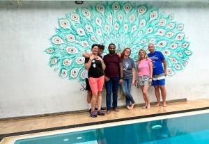 a group of people standing in front of a swimming pool at Sapphire Garden Hotel in Habarana