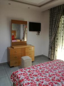 1 dormitorio con cama, tocador y espejo en s 2 1 km from the beach mansoura kelibia en Qulaybīyah