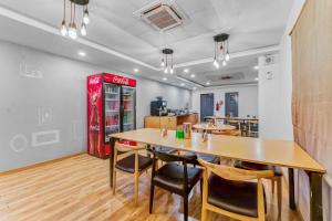 a restaurant with a table and chairs and a soda machine at Upar Hotels Nungambakkam Nearby US Consulate Apollo hospital Sankara Nethralaya in Chennai