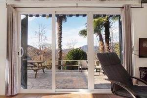 a sliding glass door with a view of a patio at Casa Maro in Brezzo