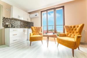 a kitchen with two chairs and a table in a room at ELİSA Park Hotel in Trabzon