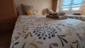 a bedroom with a bed with towels on it at ALOJAMIENTO MIRABUENOS in Aranda de Duero