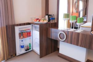 a kitchen with an open refrigerator with a bowl of fruit at Burçman Hotel Vişne in Yıldırım