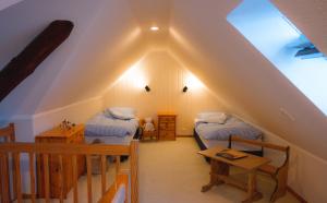a attic room with two beds and a staircase at Marin in Westermarkelsdorf