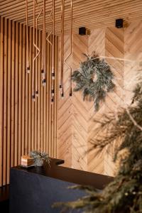 a room with a wooden wall with pendant lights at Villa Vita Krupówki in Zakopane