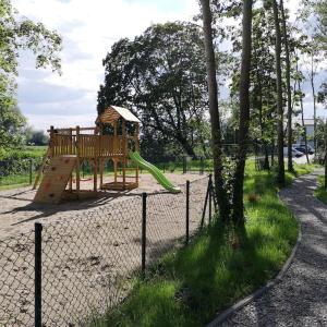 a playground with a slide in a park at Słoneczna Przystań - Apartamenty dwupoziomowe in Sobieszewo