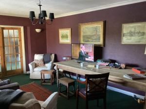 a living room with a large wooden table at Valley View Farm, Bed and Breakfast in Batcombe