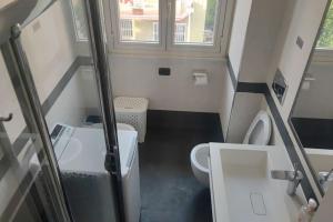 a small bathroom with a toilet and a sink at Barzo Apartment in Rome +27 photos