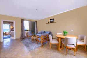 a living room with a table and chairs at Zen Resort Sahl Hasheesh by TBH Hotels in Hurghada