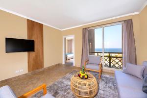 a living room with a couch and a tv at Zen Resort Sahl Hasheesh by TBH Hotels in Hurghada