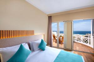 a bedroom with a bed with a view of the ocean at Zen Resort Sahl Hasheesh by TBH Hotels in Hurghada