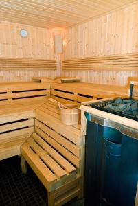 a sauna with wooden benches and a sink in it at Hotel Cult Frankfurt City in Frankfurt/Main