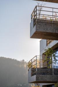 a building with a balcony on the side of it at HAY boutique hotel & SPA by Edem Family in Bukovel