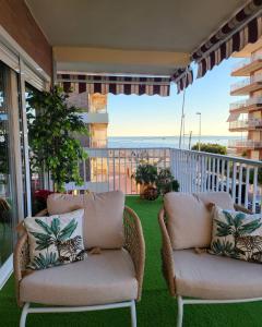 a balcony with two chairs and a view of the ocean at Apartamento Mark in Santa Pola