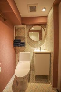 a bathroom with a toilet and a sink and a mirror at ZDT-304 in Tokyo