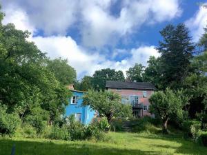 a blue house in a field with trees at Gartenhaus mit Sauna am Buckowsee, Märkische Schweiz in Buckow