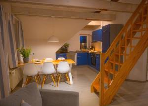 a kitchen and dining room with a table and chairs at Scirocco in Westermarkelsdorf