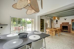 a kitchen with a table and a dining room at Villa l'Hermitage Piscine Sauna Fitness Deauville in Bénerville-sur-Mer