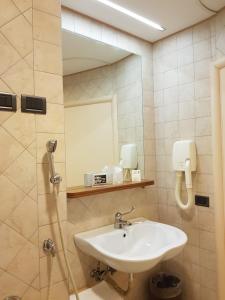 a bathroom with a sink and a mirror at Hotel dei Duchi in Spoleto