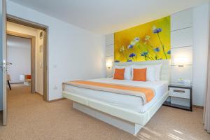a bedroom with a bed with a painting on the wall at Mera Resort in Venus