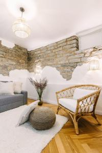 Lenderi Villa Luxury Apartments with Sauna في تالين: غرفة معيشة مع جدار حجري