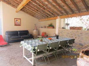 a table and chairs in a living room with a couch at La Pommeraie in Casteil +9 photos