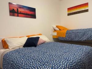 a bedroom with two beds and two paintings on the wall at Casa Dea 3 in Seriate