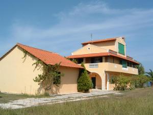 a large house with an orange roof at ARISTIDIS Apartments in Lefkimmi