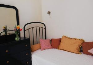 a bedroom with a bed with a dresser and a mirror at Chambres d'Hôtes Domaine du Bourg in Gannay-sur-Loire