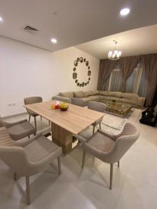 a dining room with a wooden table and chairs at Modish Classy Apartment In Jumeirah in Dubai