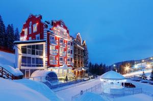 un hotel en la nieve por la noche en Chevalier Hotel & SPA en Bukovel