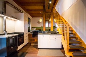 a kitchen with a staircase leading up to a loft at Gästehaus Dworschak in Leutschach