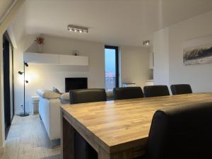 a dining room with a table and chairs at Sea Breeze 303 in Nieuwpoort