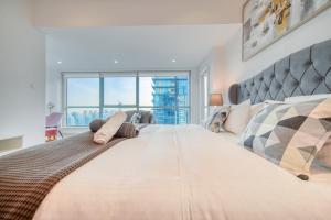 a bedroom with a large bed with a large window at The Marina PENTHOUSE near JBR 46th Floor in Dubai