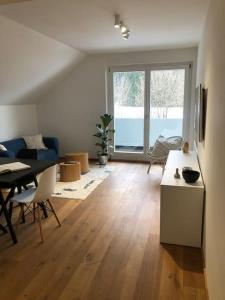 a living room with a blue couch and a table at Casa MÓRE in Niederalm