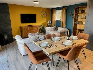 a living room with a table and a couch at The Cabin@TyddynUcha in Caernarfon