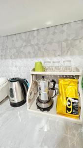 a tea kettle on a shelf in a kitchen at Bangkok Private 4Bedrooms-Parking-Weekly Special Offer in Bangkok