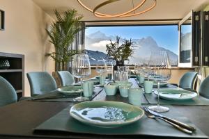 a dining room table with a view of a mountain at BergChalet in Garmisch-Partenkirchen