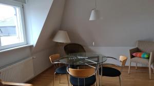 a dining room with a glass table and chairs at Art-Hotel Robert Mayer in Frankfurt